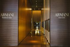 the entrance to an office building with wood paneling and glass doors on both sides