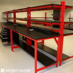 a room filled with lots of red and black shelves