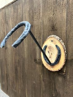 a piece of wood with an iron hook on it