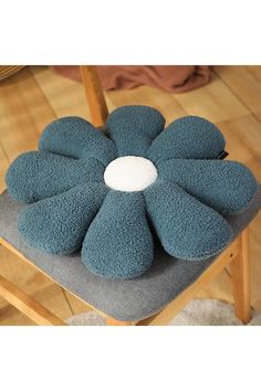 a chair with a flower shaped cushion on it