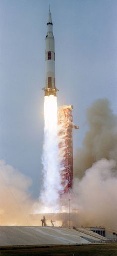 the saturn rocket lifts off into the sky