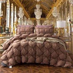 a large bed in a fancy room with chandelier