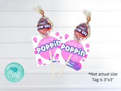 two lollipops are on top of each other with the word poppin'in them