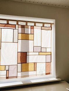 a window that has been decorated with different colored squares and rectangles on it