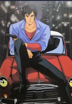 a man sitting on top of a red car in front of tall buildings with his arms crossed