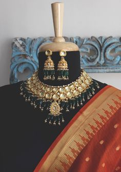 Emerald Green Gold Plated Kundan Polki Bridal Indian Choker Necklace Set with Jhumka Earrings embellished with Green Stones and Shell Pearls inspired by Sabyasachi jewellery style. Faux glass polki and shell pearls embellished Gold Plated Kundan Polki Bridal Indian Choker Necklace Set with Chandbali Earrings highlighted with red onyx tumble stones. Indian jewellery set, Indian Choker necklace set, Indian bridal jewellery, Indian wedding jewellery. Indian Necklace Set with Chandbali earrings, Ear Traditional Chandbali Jewelry Sets For Designer Wear, Designer Temple Jewelry Chandbalis For Diwali, Temple Style Chandbali Jewelry Sets With Gota Work, Traditional Kundan Temple Necklace For Designer Wear, Diwali Temple Jewelry Chandbalis For Designer Wear, Traditional Gold Jewelry Sets For Designer Wear, Diwali Designer Jewelry With Latkans, Designer Kundan Temple Necklace With Chandbali Shape, Gold Kundan Necklace With Meenakari