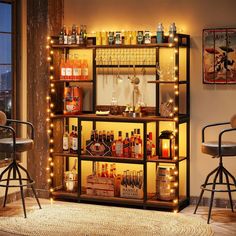 a bar with liquor bottles and lights on the shelves next to two chairs in front of a window