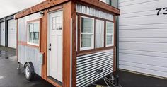 a tiny house is parked in the parking lot