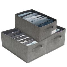 two grey storage bins filled with clothes