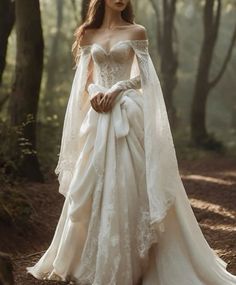 a woman wearing a wedding dress in the woods