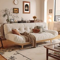 a living room with a white couch and coffee table in front of a large window