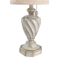 a white lamp with a beige shade on it's base and a gold trim