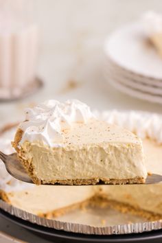 a piece of pie is being held by a fork with the rest of the pie on it