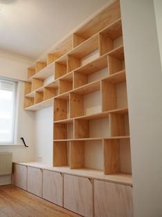 an empty room with wooden shelves on the wall