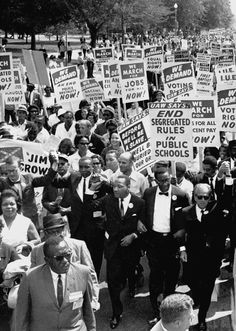 black and white photograph of people holding signs