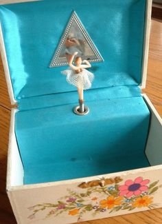 an open box with a figurine in it