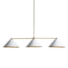 three white lamps hanging from a brass metal light fixture on an isolated ceiling, against a white background