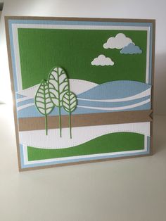 a card with trees and clouds on it