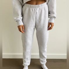 These Are High-Rise Sweatpants With A Slim Leg And Elastic Cuffs. They're Made With Tna’s Cozy Fleece Premium, Midweight Fleece With A Soft-Brushed Back, Sueded Face And Cloud-Nine Cozy Feel. They've Been Recently Redesigned For An Even More Flattering Fit. Cozy Leisure Sweats, Gray Fleece Bottoms For Loungewear, Cozy Sweatpants With Ribbed Waistband, Cozy Winter Joggers, Basic Bottoms With Ribbed Cuffs, Winter Sportswear Bottoms For Lounging, Cozy Fit Fleece Pants For Fall, Gray Fleece Winter Bottoms, Winter Loungewear Sportswear Pants