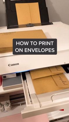 a printer that is sitting on top of a desk with some envelopes in it