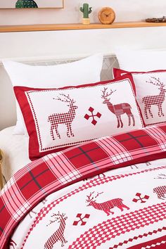 a red and white comforter with deers on it