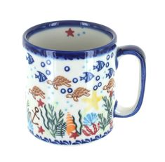 a blue and white coffee mug with marine life on the inside, sitting in front of a white background