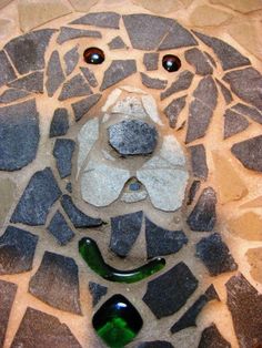 a face made out of rocks and glass bottles