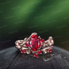 a red ring sitting on top of a wooden table next to a green background with white diamonds