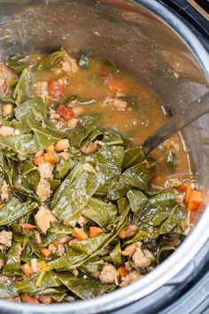 the food is being cooked in the crockpot with meat and spinach leaves