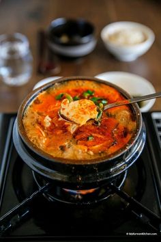 a bowl of soup on top of a stove