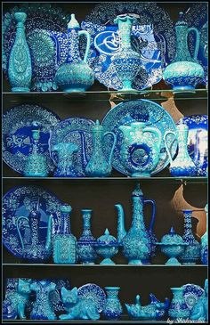 blue and white pottery is displayed on shelves