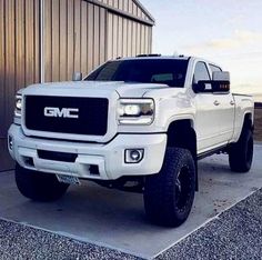 a white truck parked in front of a building