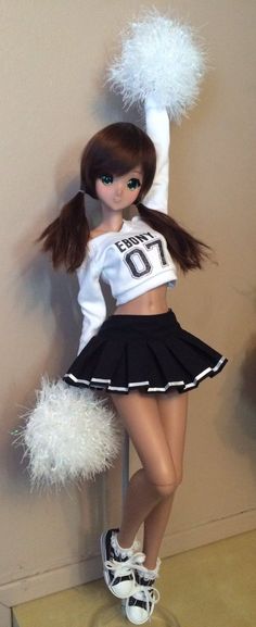 a doll dressed in a cheerleader outfit