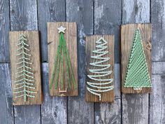 three small wooden christmas trees on wood planks