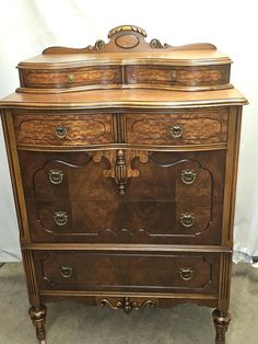 an antique chest of drawers is shown in this image