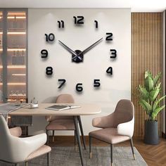 a clock that is on the side of a wall in a room with chairs and a table