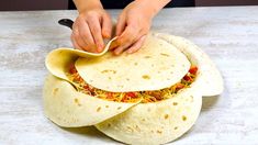 the tortilla is being cut into four pieces and placed on top of each other