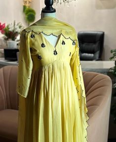 Hand embroidered Anarkali with embroidery  dupatta / yellow anarkali suit set / anarkali dupatta USA / georgette dress with embroidered scallop dupatta / Indian dresses/ voggish / haldi yellow dress         Looking for a perfect indian dress/anarkali/suit sets that are trendy, unique and easy to carry !! yess, You are at the right place. we carry such versatile pieces of anarkalis and suit sets that really let you stand out in any occassion !!      featuring this beautiful georgette dress in light lemon yellow color with hand embroidered at the front neck and body with 3/4 sleeves as shown paired with matching soft georgette scallop embroidery dupatta as shown !! A very classy, beautiful look makes your occasion Perfect !! Ready to ship !! can be customized in any color !! Details :  - col Luxury Yellow Raw Silk Anarkali Set, Luxury Yellow Anarkali Set With Dupatta, Luxury Embroidered Yellow Anarkali Set, Luxury Yellow Anarkali Kurta, Luxury Yellow Gown With Dori Work, Fitted Yellow Kurta With Sheer Dupatta, Yellow Anarkali Set With Traditional Drape, Yellow Churidar With Sheer Dupatta, Fitted Yellow Churidar With Sheer Dupatta