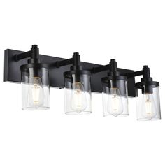 three light bathroom fixture with clear glass shades and black metal finish, on an isolated wall