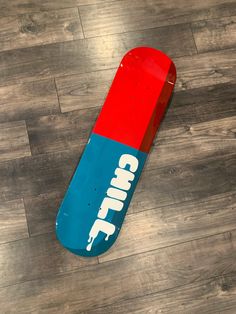 a skateboard with the word camp on it laying on top of a wooden floor