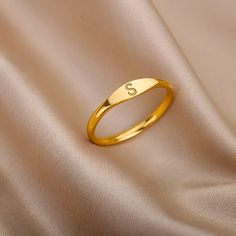 Our Initial Ring is a beautiful and elegant piece of minimalist jewelry, perfect for any occasion.  This tiny ring, available in either gold or silver, is the perfect gift for the special woman in your life. With a single initial featured prominently on the front, this ring is a subtle and sophisticated way to personalize your style.  Whether you are looking for a monogrammed piece to add to your collection or a simple, yet chic accessory to complete your outfit, this Initial Ring is sure to imp Initial Rings For Women, Ring Designs Simple Gold, Gold Rings For Woman, Gold Ring With Initials, Initial Rings For Ladies, Gold Simple Ring For Women, S Letter Rings For Women, Dainty Gold Rings Minimalist Jewelry, Ring With Initials Letters