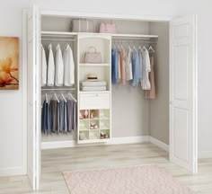 a white closet filled with lots of clothes and shoes next to a rug on top of a hard wood floor