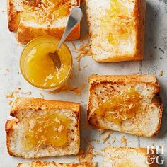 four pieces of toast with butter and honey on them next to a jar of jam