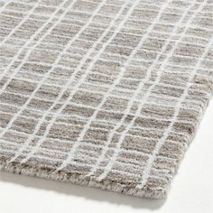 a close up view of a rug on the floor with white and gray squares in it