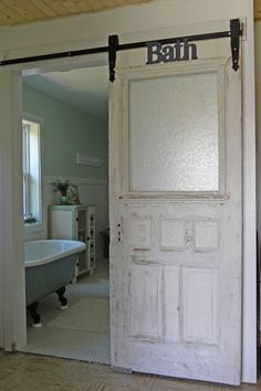 an open door leading to a bathroom with a bathtub