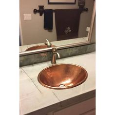 a bathroom sink sitting under a large mirror