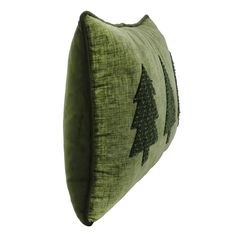 a green pillow with trees on it