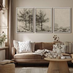 a living room filled with furniture and paintings on the wall above it's coffee table