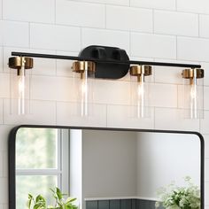 a bathroom vanity light with three bulbs on the side and a mirror in front of it