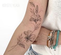 a woman with a flower tattoo on her arm